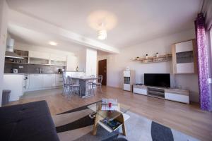 a large living room with a table and a kitchen at Apartman 2 Relax Zadar in Zadar