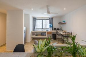 a living room and kitchen with a table and chairs at Art Studios in Cancún