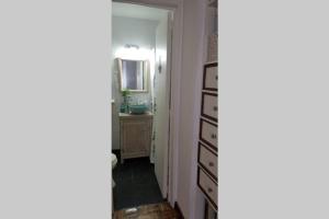a hallway with a sink and a dresser in a room at Encantador departamento in San Fernando +12 photos