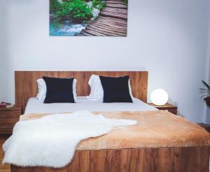 a bedroom with a bed with a white blanket at Studio Apartment in Center With Panoramic Old Town View in Prizren