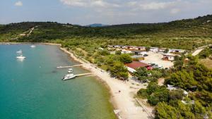 an aerial view of a beach with a boat in the water at Mobile homes Charly in Tisno