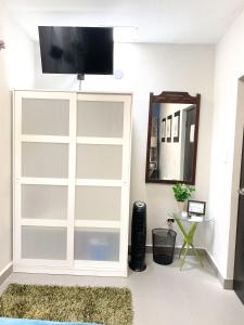 a sliding glass door in a living room with a mirror at Isla Verde By The Beach Guest House in San Juan