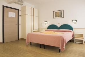 Postel nebo postele na pokoji v ubytování Hotel Alba