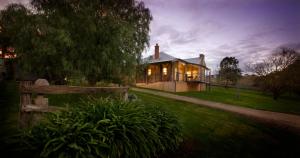 a house with a fence in front of it at Longview Vineyard in Macclesfield