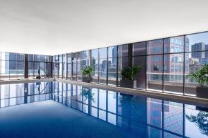 a swimming pool in the middle of a building with windows at Mantra Southbank in Melbourne