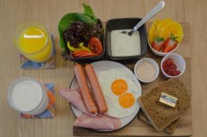 a tray of breakfast food with eggs meat and toast at Whereder Poshtel in Udon Thani