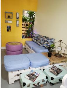 a living room with a couch and ottomans at Recycled house in Santo Domingo