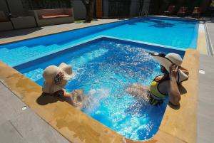 a dog is sitting in a pool of water at Crystal Suites Suvarnbhumi Airport in Lat Krabang