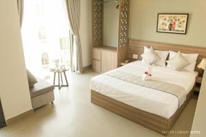 Posteľ alebo postele v izbe v ubytovaní An Hoi Canary Hotel