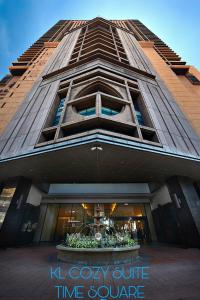 a tall building with a clock on the side of it at KL Cozy Suite Times Square in Kuala Lumpur