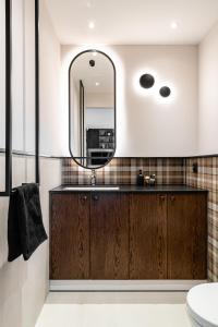 a bathroom with a sink and a mirror at Sea view apartment in Gdańsk