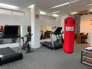 a gym with a red punching bag hanging from the ceiling at Villa MJ Maristela Beach Resort in Lemery