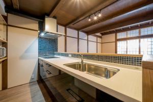 a kitchen with a sink and a counter top at RESI STAY Villa Silktree in Kyoto