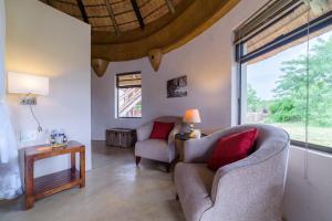 a living room with two chairs and a window at Lengau Lodge in Grietjie Nature Reserve