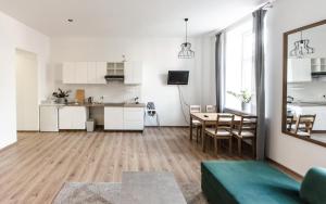 a living room with a kitchen and a dining room at Apartament Mickiewicza in Wadowice