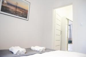 Posteľ alebo postele v izbe v ubytovaní Apartament Mickiewicza