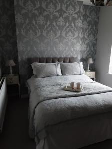 a bedroom with a bed with two candles on it at Esplanade Seaside View Apartment in Porthcawl