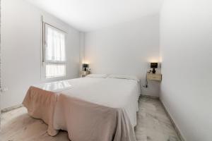 Ένα ή περισσότερα κρεβάτια σε δωμάτιο στο Apartamentos Villas Flamenco Rentals