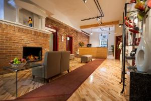 a living room with a brick wall and a fireplace at Hotel Quartier des Spectacles in Montreal
