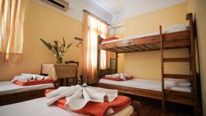 a room with three bunk beds in a hostel at The Student & Travellers Inn in Athens