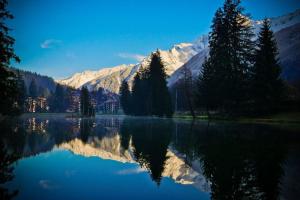 a reflection of a mountain in a lake at Vert Lodge Chamonix in Chamonix-Mont-Blanc
