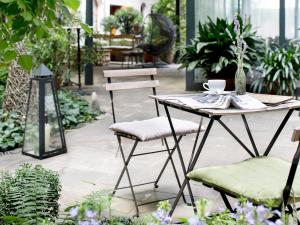 a table and chairs in a garden area at Boutiquehotel Stadthalle in Vienna