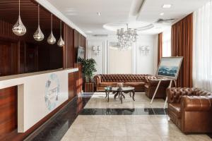 a living room with couches and a tv at Carat by Undersun in Krasnodar