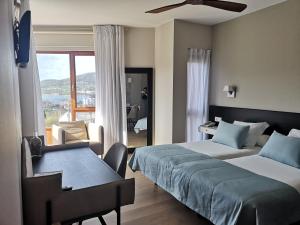 Posteľ alebo postele v izbe v ubytovaní Hotel Herbeira