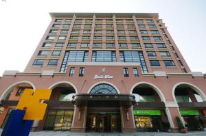 a tall building with a f sign in front of it at Zenda Suites in Tainan