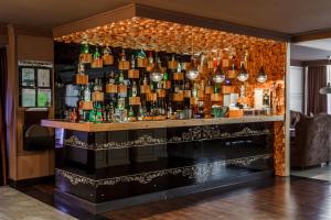 a bar with a bunch of bottles on a wall at Carat by Undersun in Krasnodar