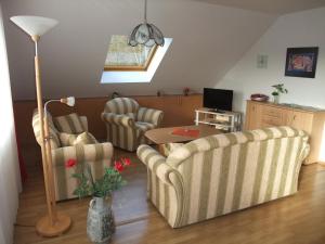 a living room with two chairs and a table at Ferienhaus Hubertus in Elend mit Balkons in Elend