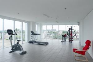 a gym with several exercise equipment in a room at Minimalist Studio Apartment at Poris 88 with City View By Travelio in Tangerang