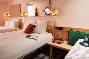 
a hotel room with a bed and a desk at Mama Shelter London - Shoreditch in London
