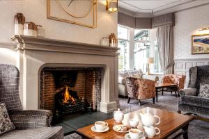 
a living room filled with furniture and a fire place at The Inn On The Lake in Glenridding
