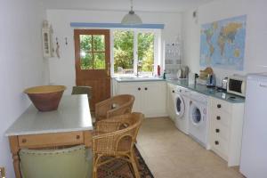 a kitchen with a washer and dryer in it at Halcyon in Harrogate