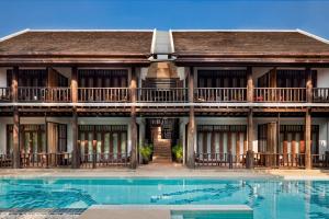 a house with a swimming pool in front of it at Maison Dalabua in Luang Prabang