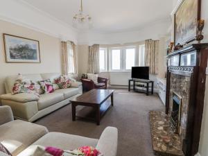 a living room with a couch and a fireplace at Seascape in Bridlington