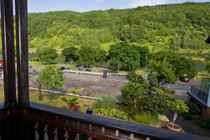 a view from a balcony of a road and trees at Pension Mosella , Wohnung mit Balkon und Moselblick in Sankt Aldegund