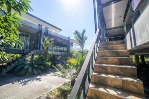 a stairway leading up to a house with palm trees at Green Mango in Thong Sala