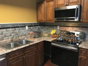 a kitchen with a sink and a stove and a microwave at Your Midwest Dunes Vacation Tri-State Paradise! in Chesterton