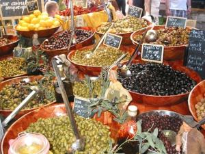 a display of different types of olives and other fruits at My rima in Antibes