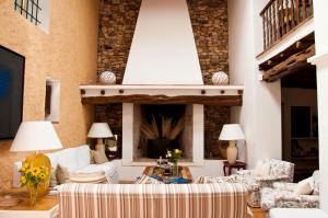 a living room with white furniture and a fireplace at Cas Gasi in Santa Gertrudis de Fruitera