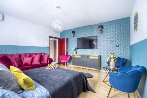 a bedroom with a purple bed and a tv at ClickTheFlat Palace of Culture View Apartment - Marszałkowska St. in Warsaw +10 photos