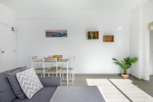 a living room with a couch and a table at APARTAMENTO COR DO MAR - Sunny, Clean and spacious apartment with sea view, in Alvor - very close walking distance to the beach and Alvor Village in Alvor +24 photos
