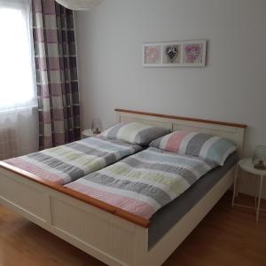 a bed with two pillows on it in a bedroom at Apartment Dachsteinblick in Bad Aussee +27 photos
