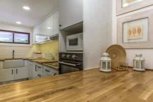 a kitchen with a wooden table in a room at FLH Victory Village Apartamento Quinta do Lago in Almancil
