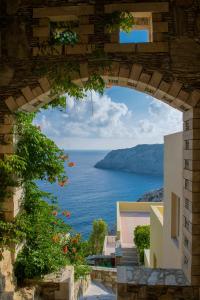 an archway with a view of the ocean at Athina Palace Resort & Spa in Agia Pelagia