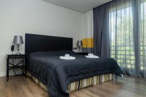 a bedroom with a bed with two towels on it at Royal Tennis Club in Marbella