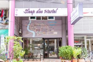 a building with a sign that reads sleep disco hotel at Sleep Dee Hostel in Bangkok