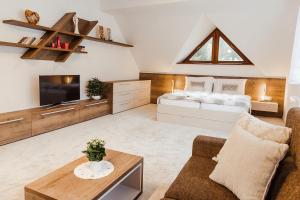 a living room with a bed and a couch at Villa Silvia in Zuberec